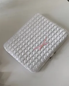 Cute quilted laptop sleeve with pink bow, white heart embroidered tablet storage bag.