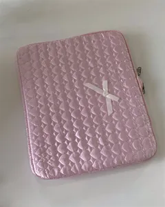 Pink quilted heart tablet sleeve detail shot showing cute bow decoration and soft zipper design.