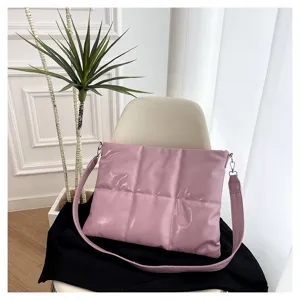 Quilted puffer laptop shoulder bag detail view, soft pink glossy material and strap metal buckle.