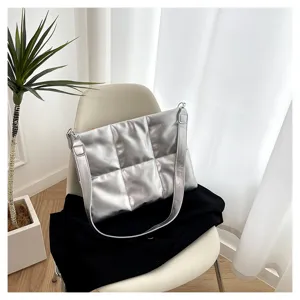Silver metallic puffer laptop shoulder bag, spacious crossbody design for 15.6 inch device.