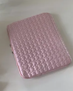 Pink heart quilted laptop sleeve detail view, cute tablet storage bag with zipper closure.