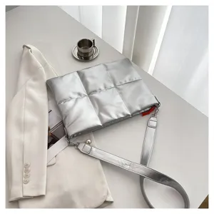 Silver padded crossbody bag detail, lightweight puffer laptop bag for daily use item.