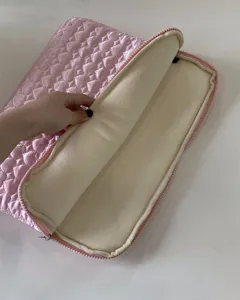 Pink quilted heart laptop sleeve detail showing soft plush fleece interior lining for 11/13 inch tablet