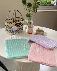 Cute quilted aesthetic laptop sleeve with heart embroidery and bow for iPad and tablet storage.