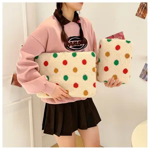 Cute plush laptop sleeve and tablet bag with colorful polka dots, soft fleece texture.