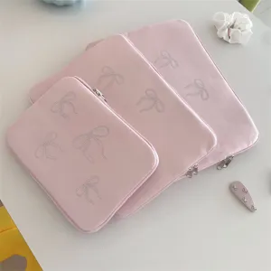 Pink velvet laptop sleeve with sparkling rhinestone bows, cute aesthetic tablet storage bag.