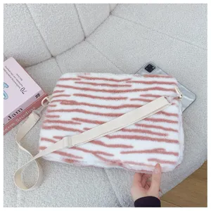 Plush tablet sleeve detail showing soft pink tiger stripe fabric and adjustable strap.
