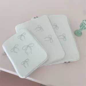 Close up view of cute rhinestone bow laptop sleeve and tablet storage bag texture and details.
