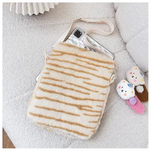 Close-up of fluffy tiger stripe plush tablet bag detailed texture cozy soft fabric accessory view