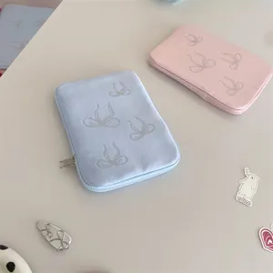 Detailed shot of cute rhinestone bow laptop sleeve and ipad protective case in pastel colors.