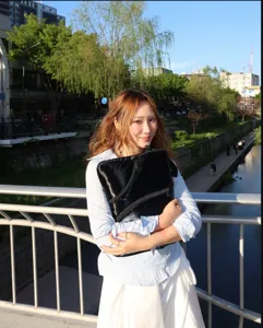 Detail view of the sleek black Y2K laptop sleeve held outdoors, showcasing shiny trendy style.