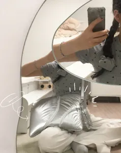 Detailed lifestyle view of the silver metallic Y2K style puffy shoulder bag worn in a mirror selfie.