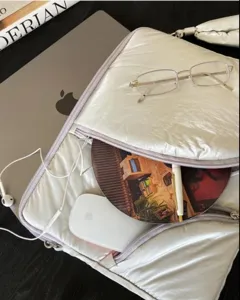 Detailed shot of Y2K silver padded laptop sleeve and inner layout with accessories.