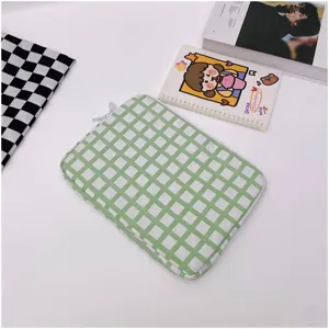 Detailed view of the green grid padded laptop sleeve, soft interior for shockproof protection.
