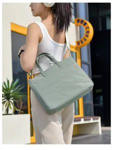 Detailed view of a minimalist casual commuter tote bag worn on shoulder outdoors.