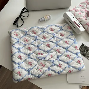 Aesthetic floral quilted laptop sleeve with blue ribbons and pink roses for tablet bag.