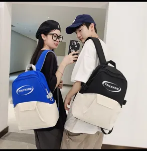 Detail view of stylish casual contrast color campus backpack with bold front letter print.