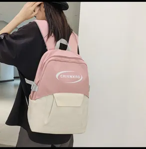 Detail view of the stylish contrast color school backpack, showing front pocket and durable straps.