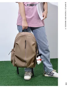Casual large capacity khaki backpack with zipper and side pockets for daily travel use.