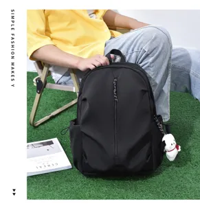 Trendy casual black backpack for men and women, large capacity lightweight school bag.