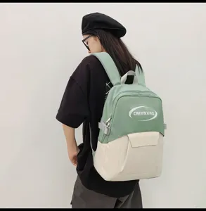 Korean style casual student laptop backpack detail showing green and beige color block design.