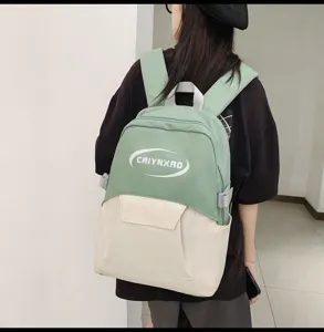 Detail shot of the casual dual-color backpack featuring adjustable straps and front pocket.
