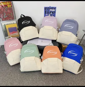 Detail view of multi-color casual canvas backpacks displaying various bright color combinations.