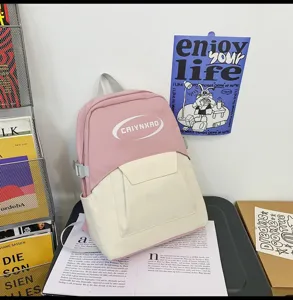 Close-up detail of the stylish pink and beige campus backpack, highlighting contrast color design.