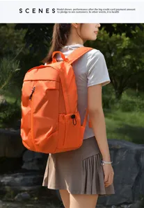 Outdoor orange travel backpack lifestyle detail view showcasing outdoor use in park setting.