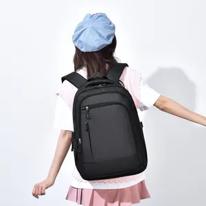 Detail view of black grid commuter backpack worn by model, showing casual style and back design.