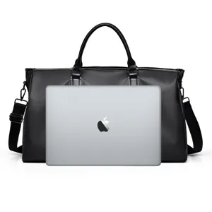 Detailed view of the black travel duffel bag showing large capacity with a laptop inside.