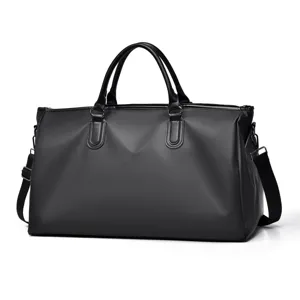 Black travel duffel bag detail, large capacity gym sports luggage with sturdy handles and shoulder strap.