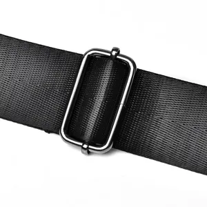 Detailed shot of adjustable metal buckle on black bag strap, durable hardware design for bags.