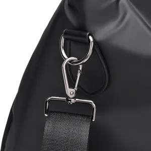 Detailed view of black gym bag metal hardware clasp and durable nylon shoulder strap.