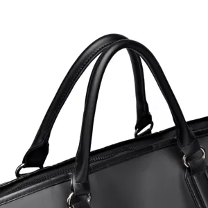 Black leather travel gym bag handle detail close-up showing fine stitching and metal hardware.