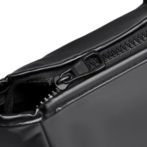 Waterproof gym duffel bag zipper detail, black travel sports handbag close-up view.