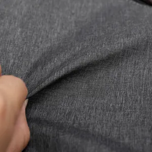 Close-up view of dark grey water-resistant textured fabric material detail for chest bag.