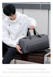 Spacious grey travel duffel bag showing handle details and versatile carrying options for daily gym.