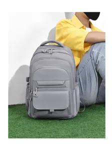Detail view of grey large capacity school backpack showing multi-pocket design and front zippers.