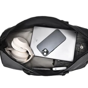 Detailed view of the large capacity black travel duffel bag showing organized interior storage.