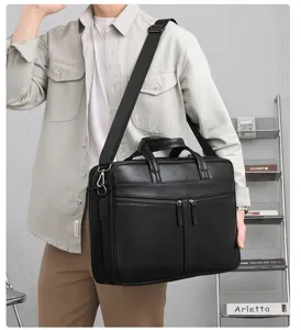 Men business briefcase detail, black leather laptop bag with strap and multi compartments for work.