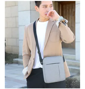 Grey nylon crossbody bag detail worn by model outdoors, lightweight shoulder bag design.