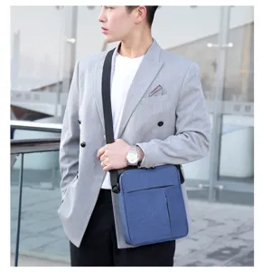 Close-up view of the lightweight nylon crossbody bag showing fine fabric and front zipper pocket.