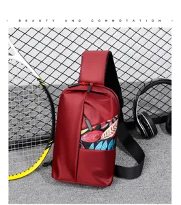 Detailed view of the casual chest bag featuring colorful leaf print pocket and durable red fabric.
