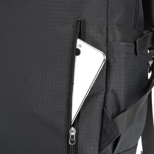 Black travel backpack detail featuring a convenient zipped pocket for secure phone storage.