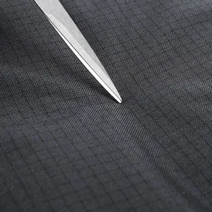 Close-up detail of the durable dark grey grid fabric, showing wear-resistant material quality.