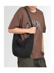 Detailed view of a black minimalist croissant shoulder bag, soft lightweight dumpling crossbody.