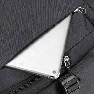 Black backpack detail showing durable fabric texture, zipper and convenient tablet pocket.