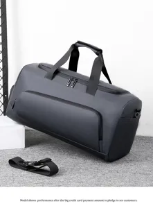 Detailed view of the dark grey waterproof gym duffel bag with shoulder strap and design.
