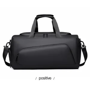 Detailed view of the black waterproof travel duffel bag with large capacity and straps.
